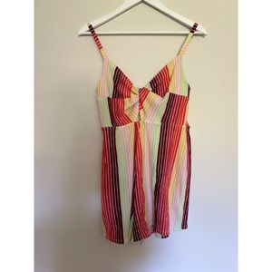 Comfy stretchy short romper. Colorful and fun. Slight cut out on the front.